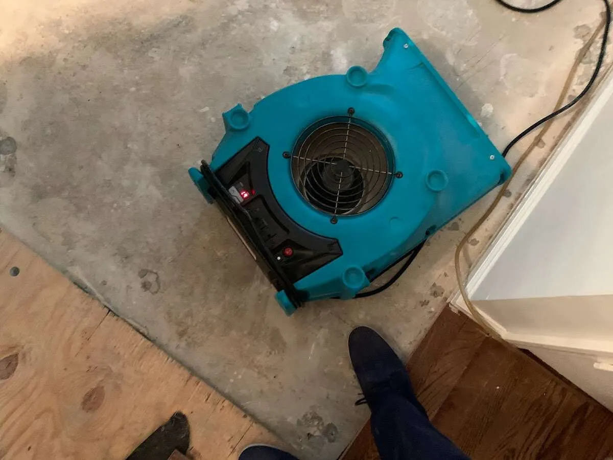 Air mover drying subfloor during Commercial Water Damage Restoration in Morris